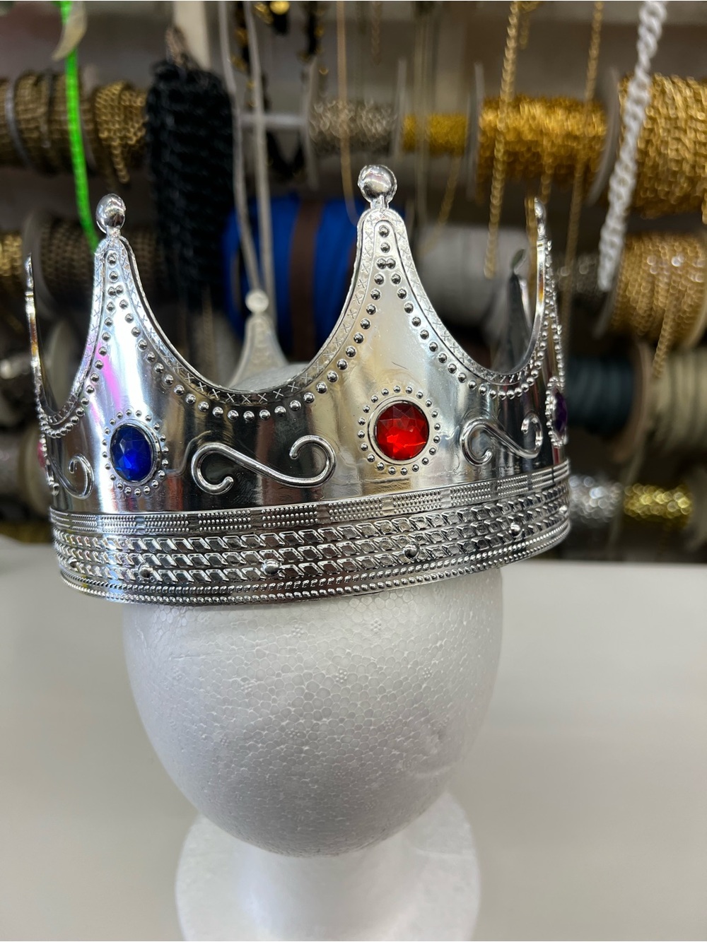 Silver Decorative Crown with Red and Blue Gem Accents